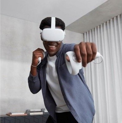 A man happily playing with a vr headset in an action pose